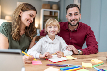 parents sitting in an office with their daughter